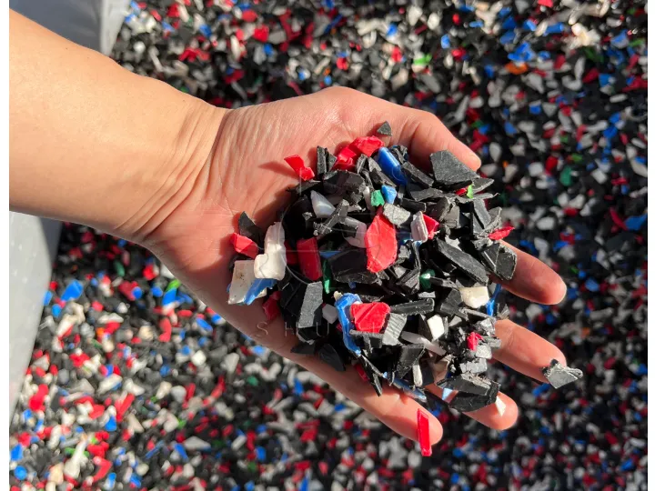 Final uniform plastic flakes output from the hard plastic crusher, ready for washing and granulation